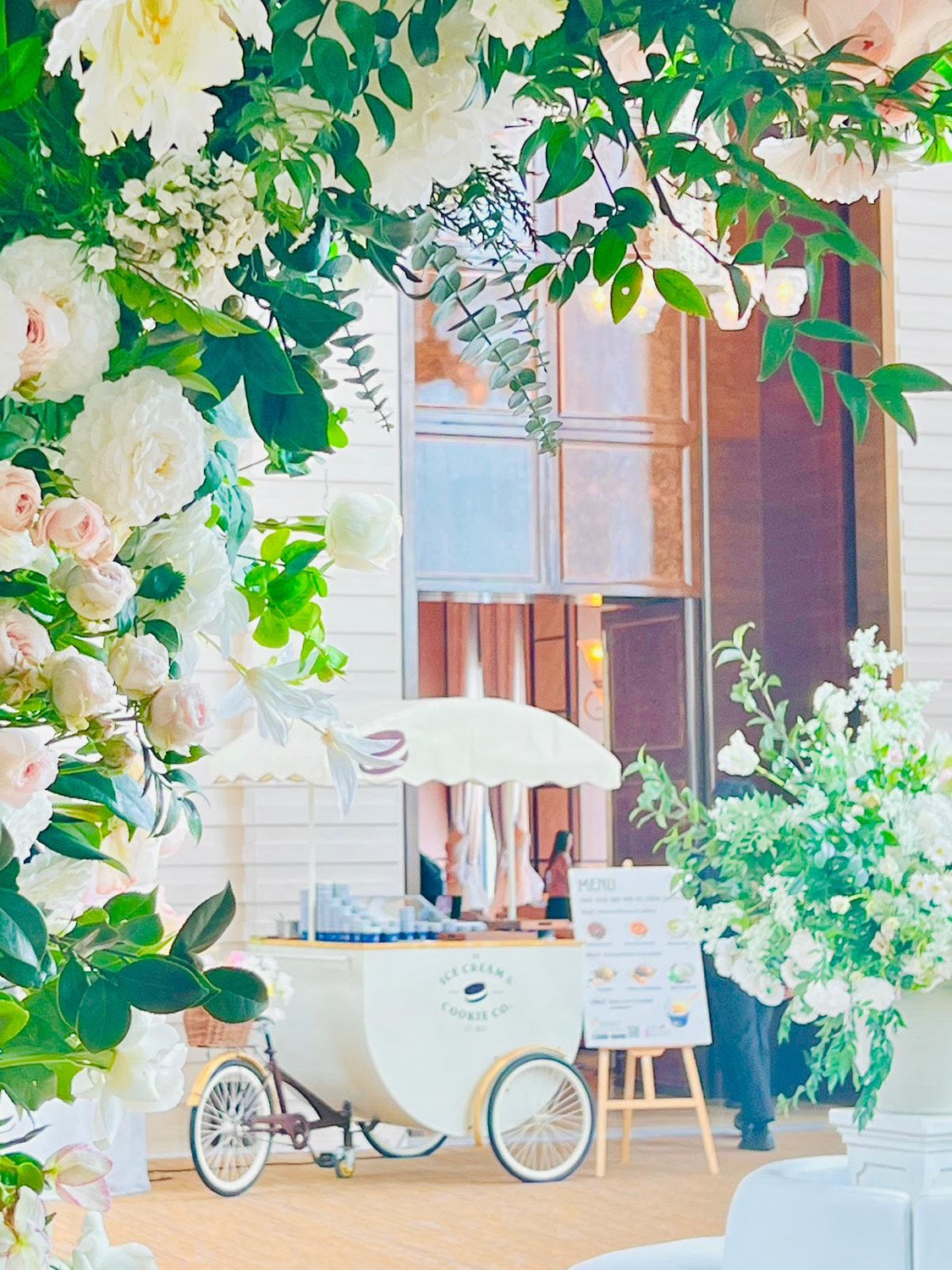 Cart beneath a floral arch